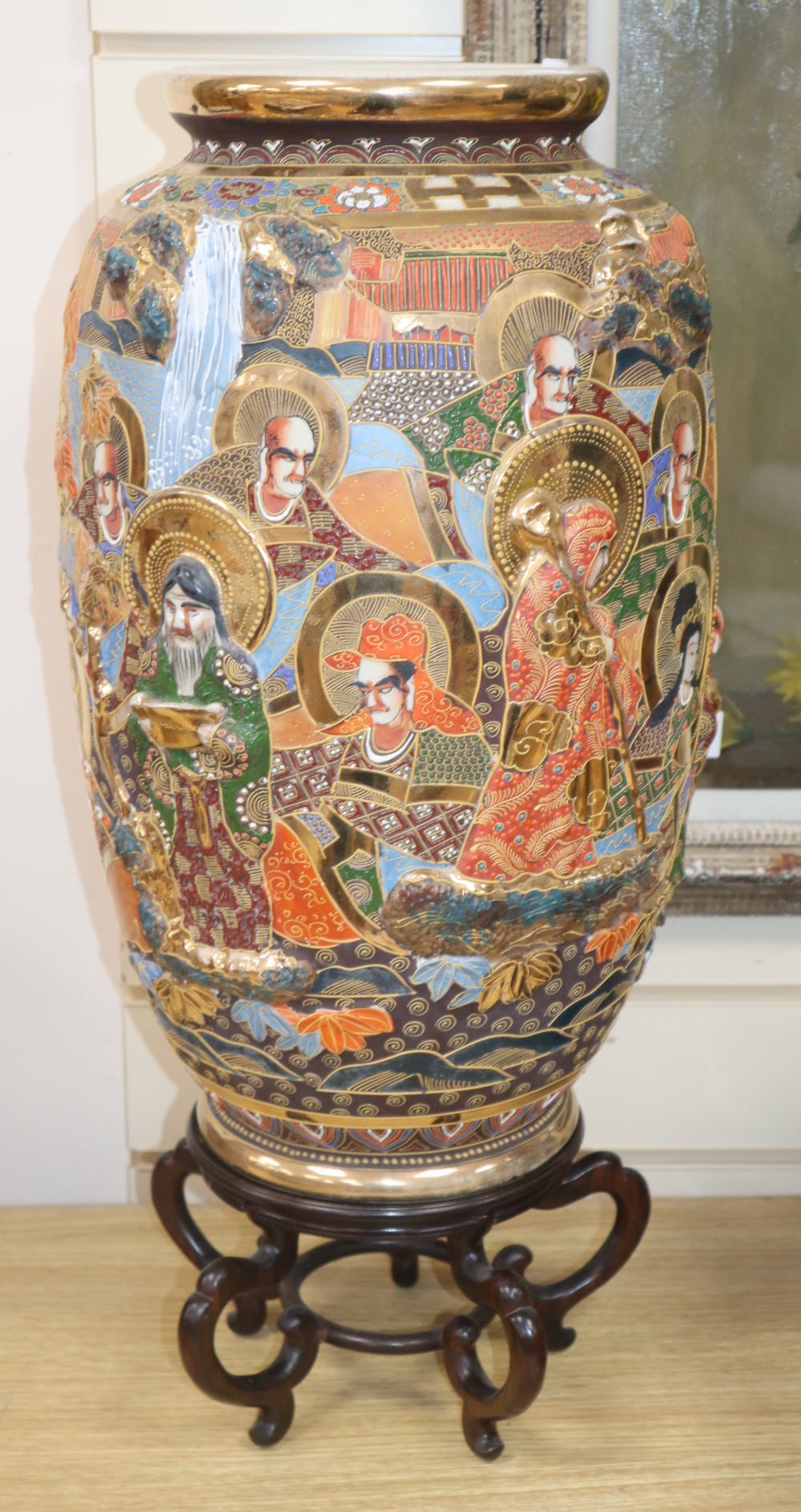 An early 20th century Japanese Satsuma ovoid pottery vase, 46cm, on hardwood stand